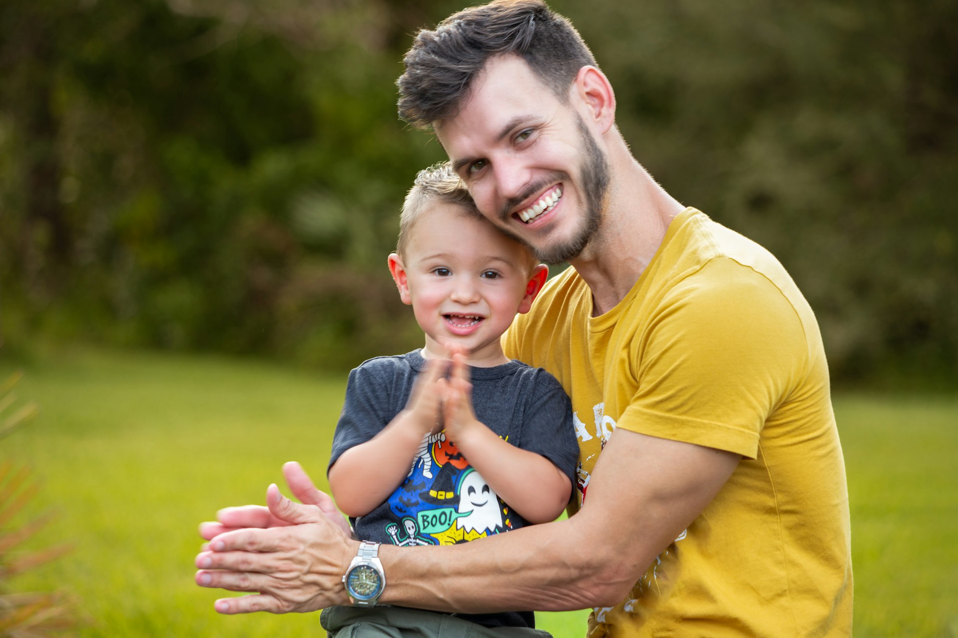 Father and son smiling outdoors